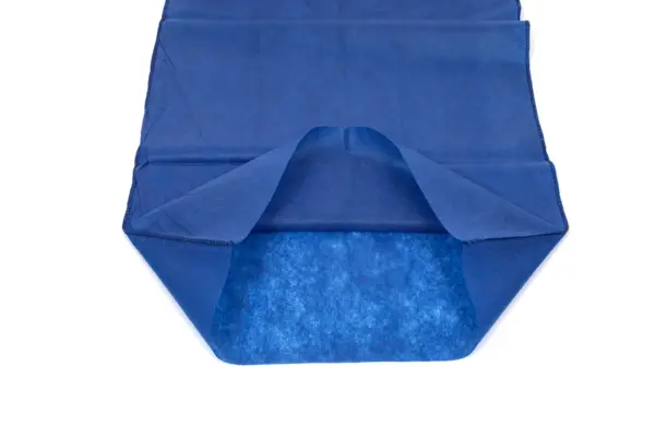Blue disposable absorbent garment liner on white Open blue nonwoven disposable garment liner with folded side flaps and a textured absorbent panel, shown on white.
