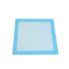 Blue disposable absorbent underpad with a large white quilted center panel, laid flat against a plain white background.