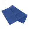 Folded blue fabric cloth on a white background A rectangular blue fabric cloth lies loosely folded on a clean white background, showing stitched edges and soft creases.