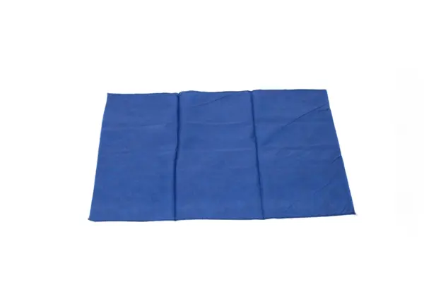 Folded blue fabric cloth on a white background Rectangular blue fabric cloth laid flat on a white background, with visible creases, stitched edges, and a soft texture.