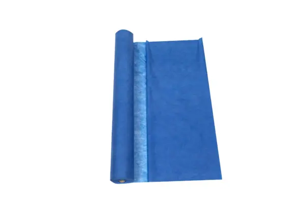 Blue rolled fabric with a textured surface, partially unrolled to display its full width against a white background.
