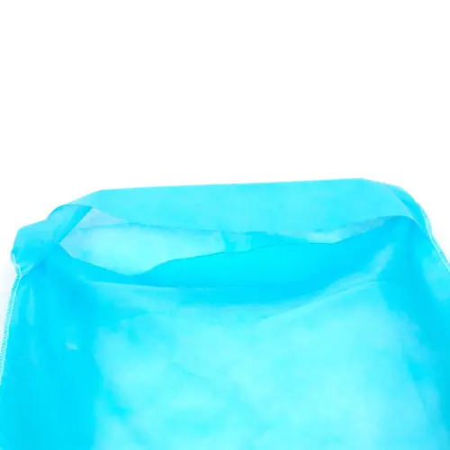 Open blue nonwoven fabric bag on white background Close-up of an open bright blue nonwoven fabric bag with folded edges and stitched side seams against white.