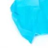 Close-up of bright blue nonwoven fabric Bright blue semi-transparent nonwoven fabric shown in close-up, with folded layers and stitched edge on white background.