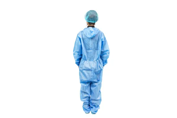 Back view of blue protective coverall Person viewed from behind wearing a blue disposable protective coverall, hair cap, and covered footwear on white background.