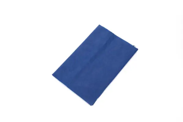 Blue square fabric cloth on a white background Blue square cloth with a fine textured surface, displayed flat at an angle against a plain white background