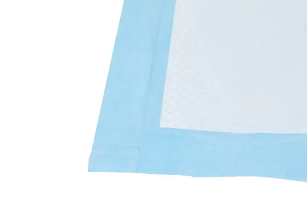 Close-up of a white absorbent pad with a pale blue border and a textured, diamond-patterned inner layer.