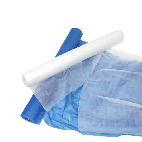 Blue and white rolled nonwoven fabric overlap on a white background, with translucent material spread across the lower frame.