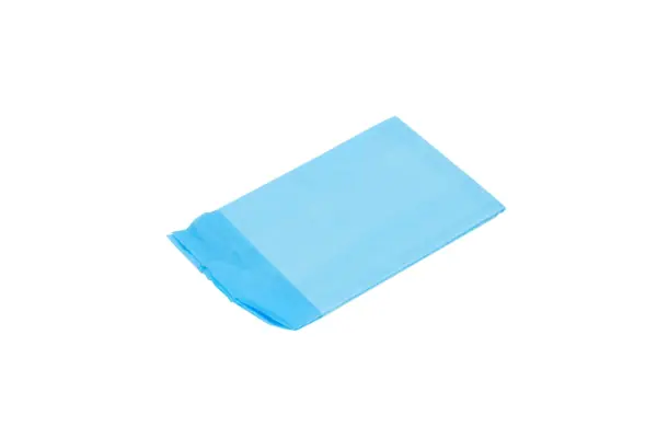 A folded light blue rectangular plastic sheet lies diagonally on a white background, with layered edges visible at one end.