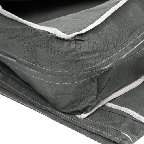 Stacked green fabric organizers with white trim Close-up of folded dark green fabric organizers featuring textured material, white edging, stitched seams, and layered panels.