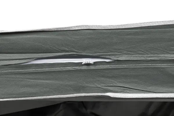 Close-up of a partially open zipper on green fabric Green textured fabric shown in close-up with a partially open white zipper and visible inner lining
