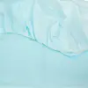 Close-up of pale blue lightweight fabric, showing gathered elastic edging, soft folds, and a smooth textile surface.