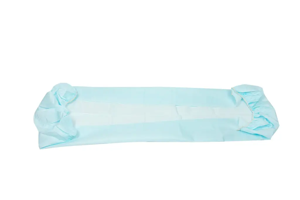 Light blue disposable medical drape spread flat, with gathered folded ends and a long rectangular center panel.