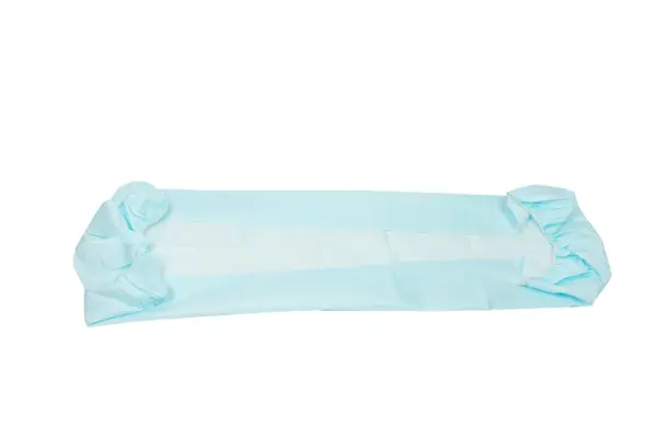 Light blue disposable medical drape spread flat, with gathered folded ends and a long rectangular center panel.