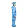 Medical worker wearing blue protective coveralls Healthcare worker in blue protective coveralls, hair cover, face mask, and shoe covers stands in profile against white