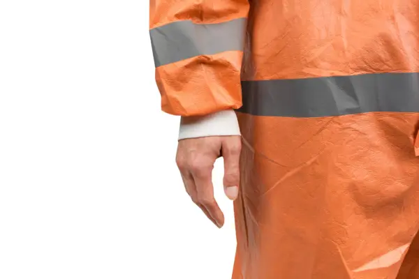 Close-up of orange high-visibility rainwear Close-up of a person wearing a wrinkled orange high-visibility waterproof jacket with wide gray reflective bands.