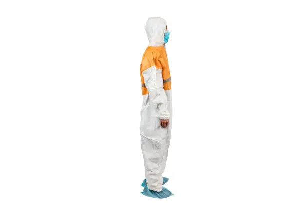 Orange and white protective coverall in profile Person in an orange and white protective coverall, blue face mask, hood, and shoe covers shown in side profile