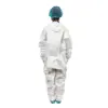 Cleanroom worker in protective coveralls Person viewed from behind wearing a white protective coverall, blue hair cover, and blue shoe covers on a white background