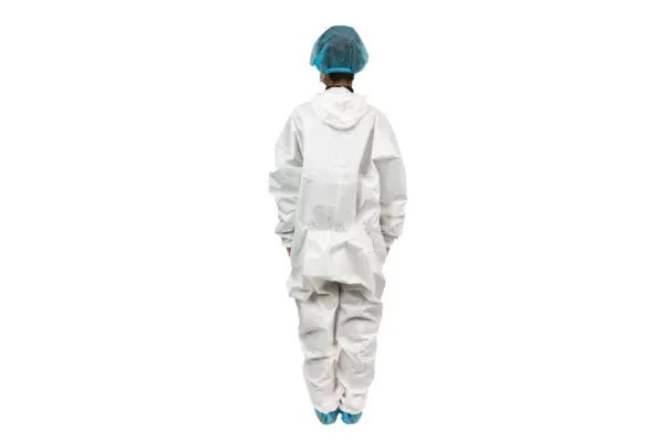 Cleanroom worker in protective coveralls Person viewed from behind wearing a white protective coverall, blue hair cover, and blue shoe covers on a white background