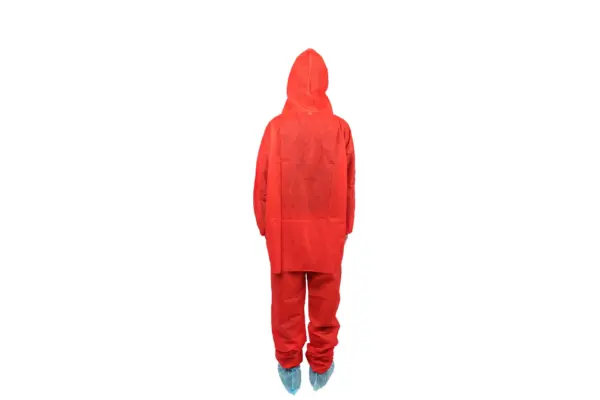 Back view of a red hooded protective coverall Person seen from behind wearing a bright red hooded protective coverall with long sleeves and blue shoe covers.