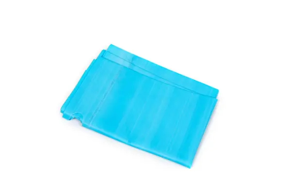 Stacked blue disposable face masks on white Several blue pleated disposable face masks are stacked at an angle against a clean white background