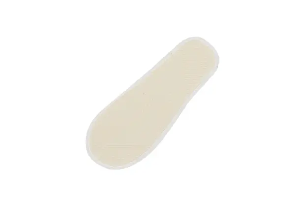Cream textured pad with rounded edges Cream-colored elongated pad with a raised textured surface and white edging, shown diagonally against a plain background