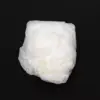 White disposable diaper on a black background Crumpled white disposable diaper shown from the outside, centered against a plain black background.