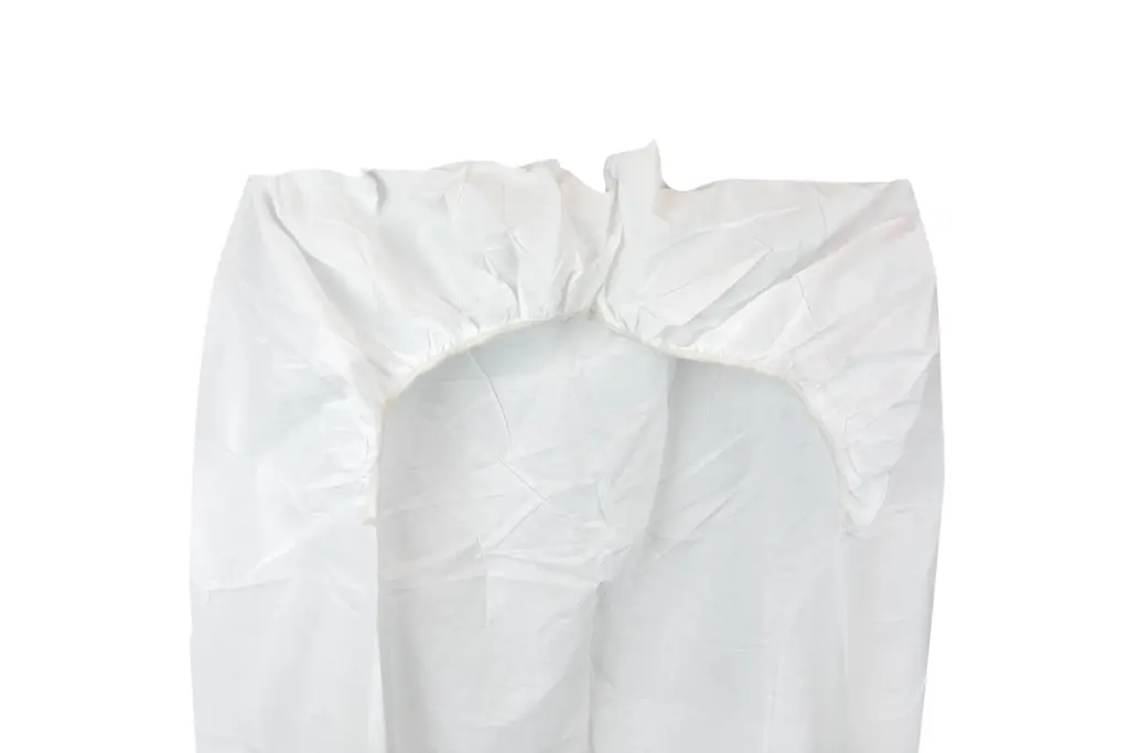 White disposable protective coverall with a gathered hood and long sleeves, displayed flat against a plain background.