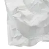 Close-up of a white crinkled protective cover featuring two large elasticated circular openings and gathered edges.