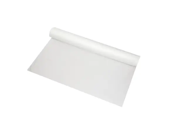 A large roll of thin white plastic sheeting partially unrolled across a clean white background, showing its smooth surface.