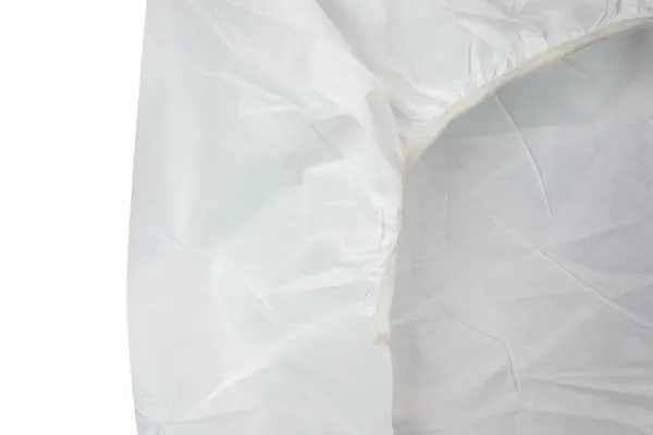White translucent textured fabric fills the frame, showing overlapping folds and a stitched seam along the right side.
